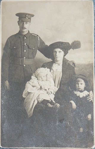 Photograph of Sidney James Robinson (4/KRRC) with his wife, Alice, and sons, Sidney and William, probably taken in autumn 1914.
